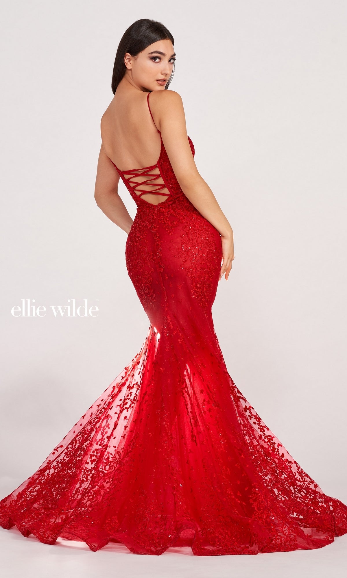 A woman poses in the Sequin-Lace Open-Back Long Mermaid Prom Dress, a red, floor-length fitted gown featuring sequin-lace fabric, sparkling embellishments, and a lace-up back.